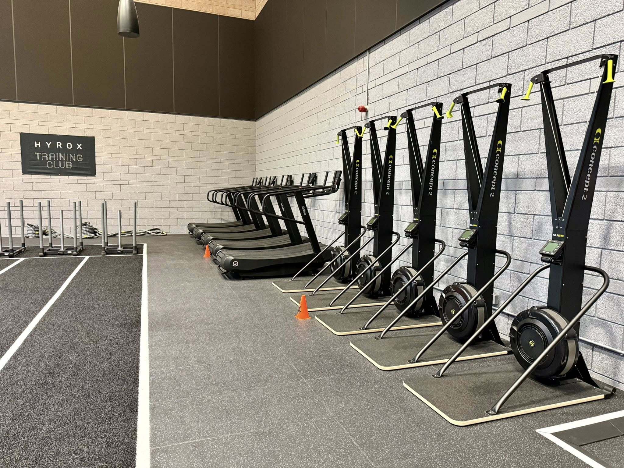 Row of SkiErg machines and treadmills in Studio 3, the HYROX studio at Inverness Leisure