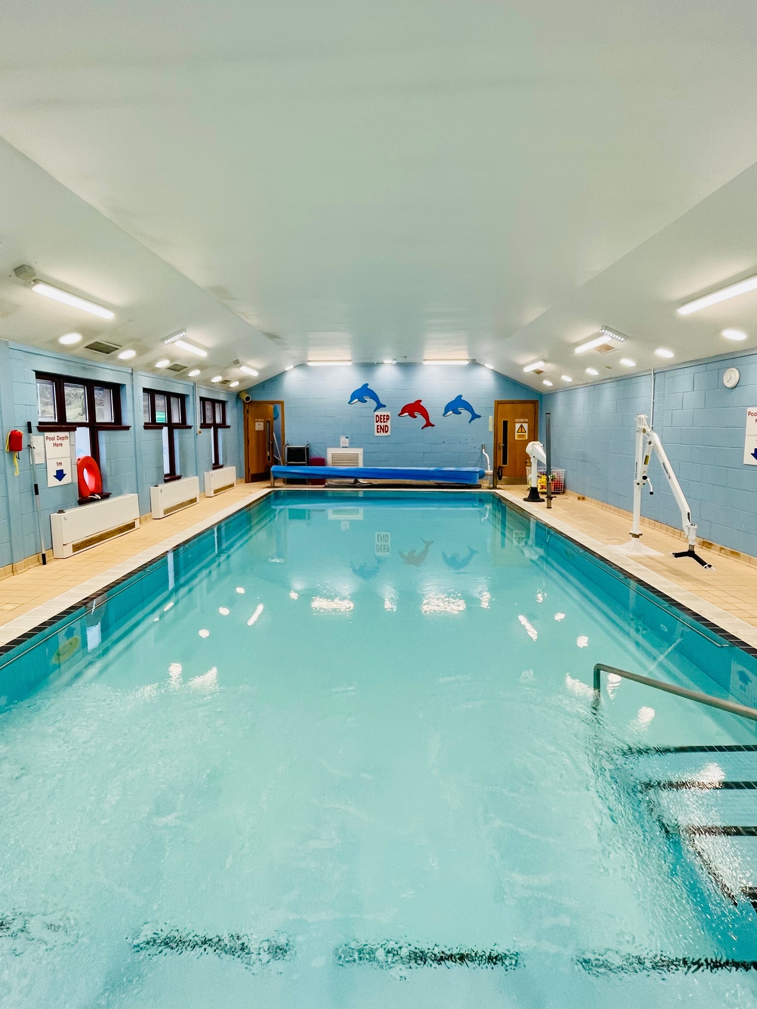 Small pool with steps and a rail leading into water.