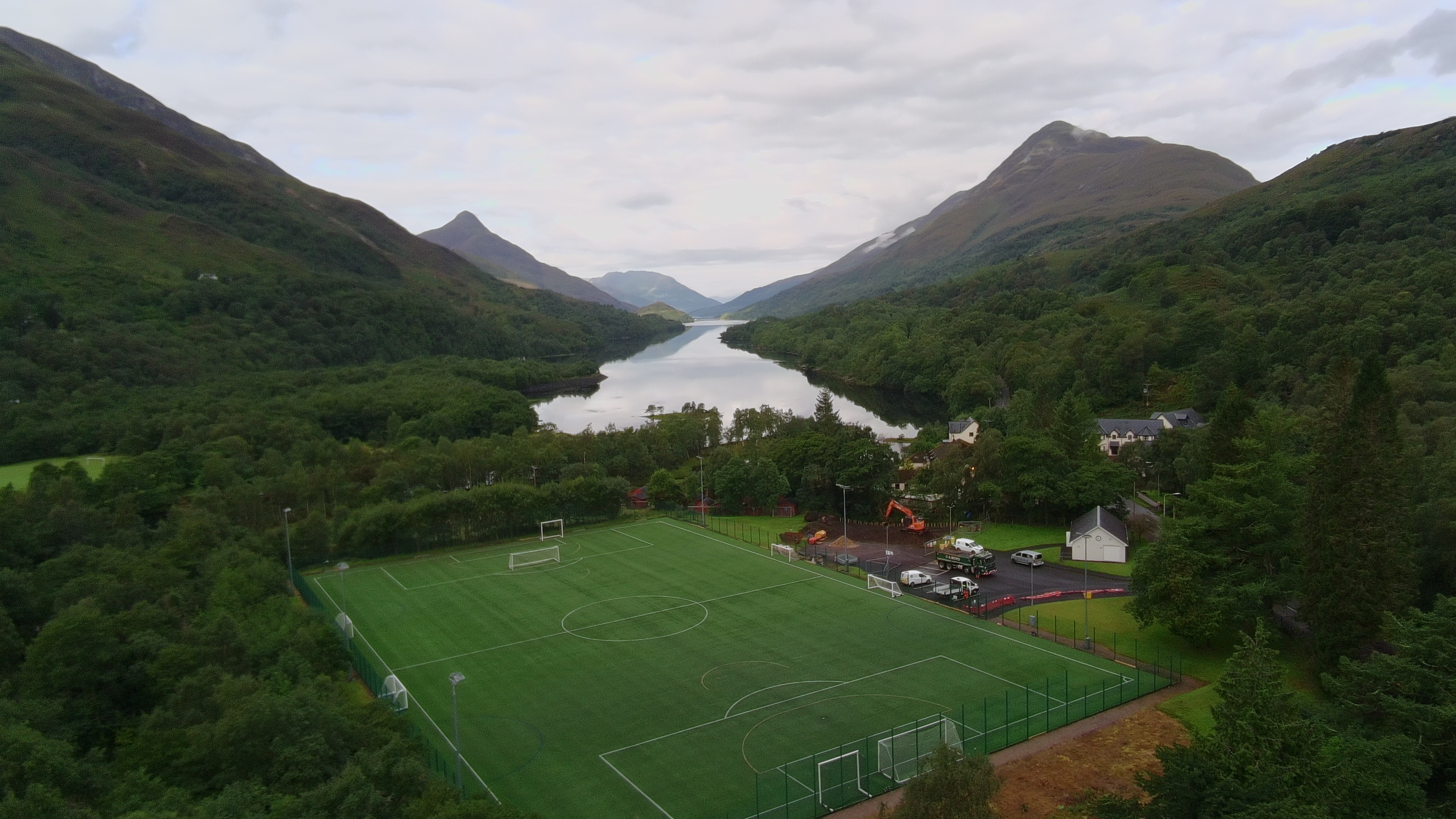 The Leven Centre aerial photo, with a loch and mountains in the background.
