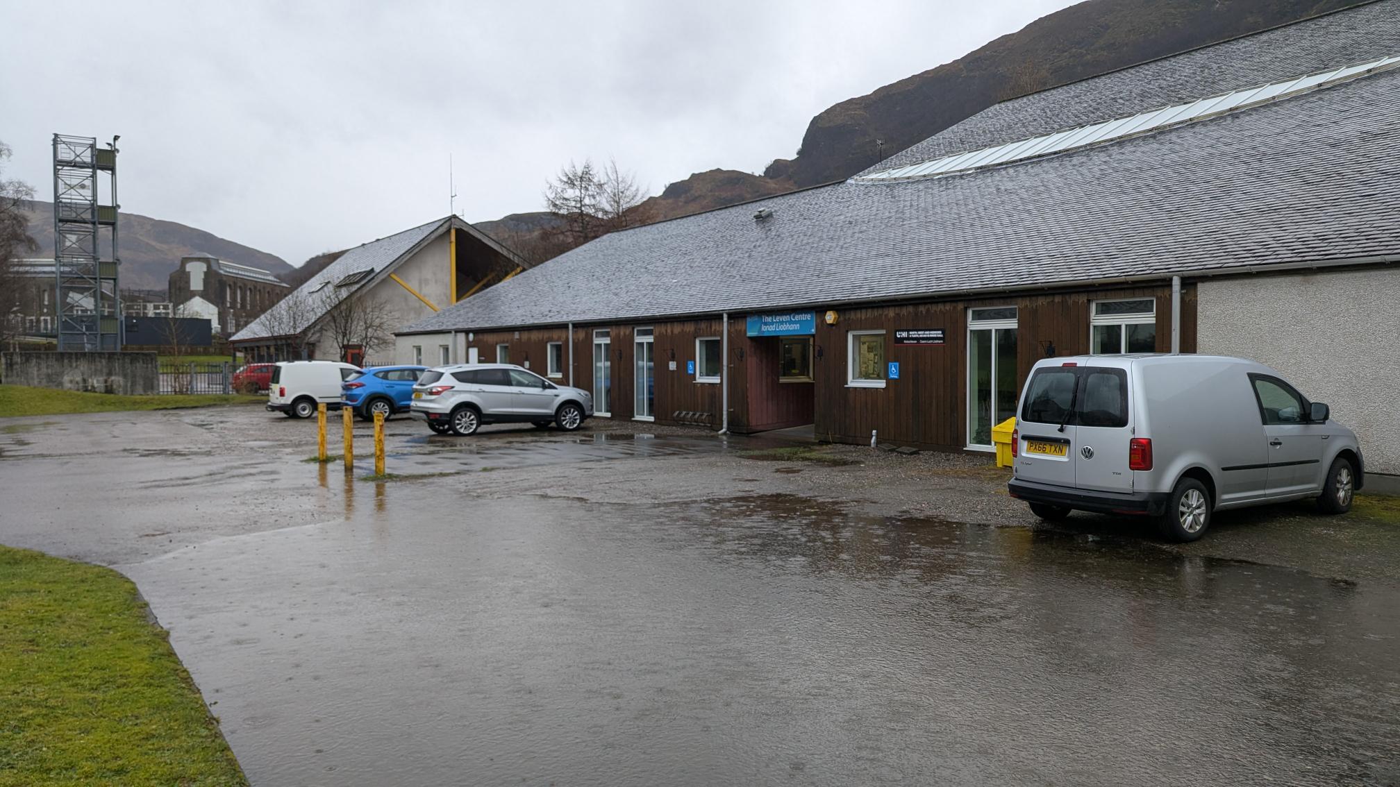 Single storey building with car parking in front of the building.