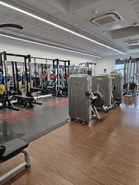 Interior of a gym inlcuding cardio and weight machines.