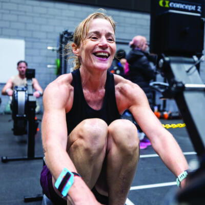 Woman laughing during a HYROX training session