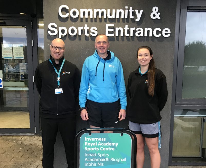 Photo (from L to R): Ross Dudgeon (Leisure Manager), Phill Blase (Leisure Supervisor) and Catrionna Russell (Leisure Supervisor) stand outside the entrance of Inverness Royal Academy Sports Centre.